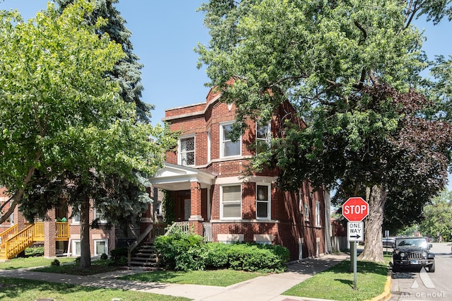 2339 S 61st Ave, Cicero, IL 60804 - multi unit property with brick siding, stairway, covered porch, and a front yard