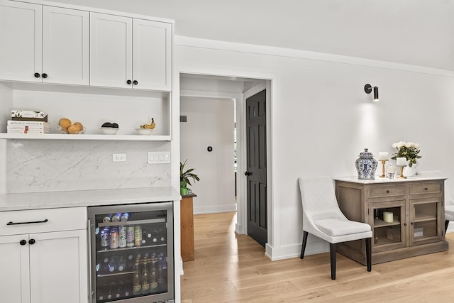 692 S Waukegan Rd, Lake Forest, IL 60045 - bar with beverage cooler, light wood-style floors, and decorative backsplash