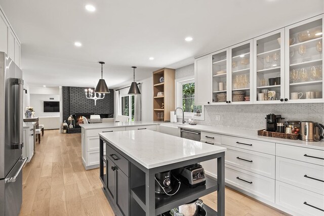 692 S Waukegan Rd, Lake Forest, IL 60045 - kitchen featuring open shelves, a peninsula, white cabinets, a fireplace, and recessed lighting