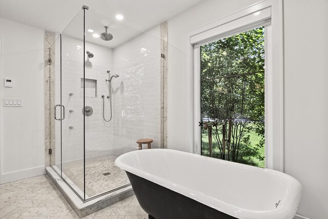 692 S Waukegan Rd, Lake Forest, IL 60045 - full bathroom with marble look tile flooring, a stall shower, a freestanding bath, and recessed lighting