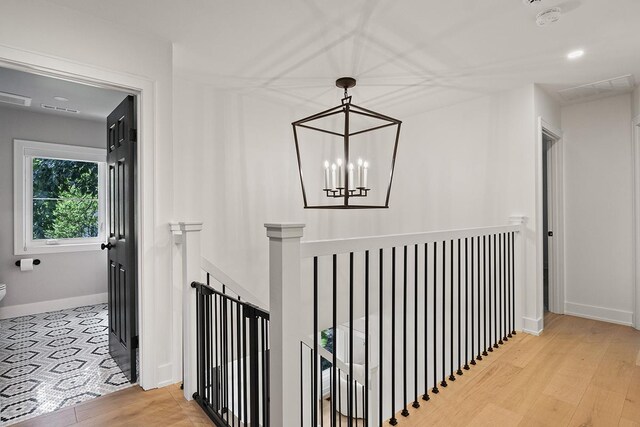692 S Waukegan Rd, Lake Forest, IL 60045 - hall featuring an upstairs landing, wood finished floors, and a chandelier
