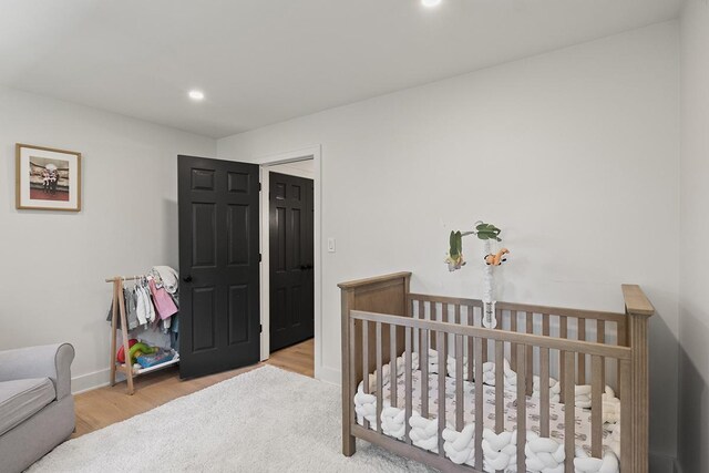 692 S Waukegan Rd, Lake Forest, IL 60045 - bedroom featuring wood finished floors, recessed lighting, and a nursery area