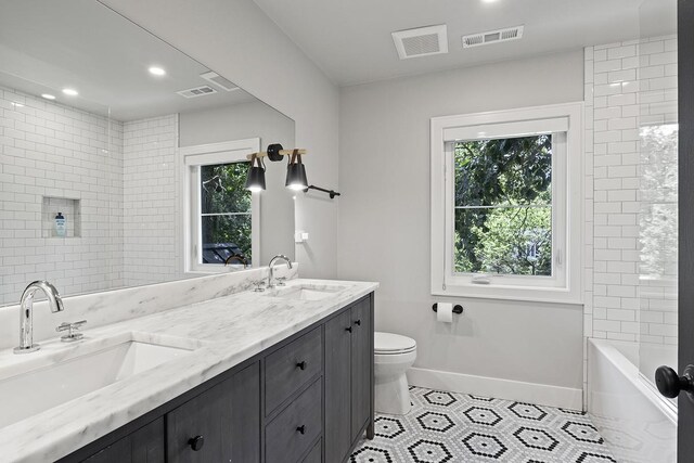 692 S Waukegan Rd, Lake Forest, IL 60045 - full bathroom featuring double vanity, tile patterned floors, plenty of natural light, recessed lighting, and tub / shower combination