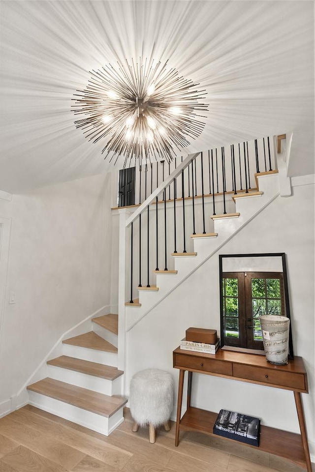 692 S Waukegan Rd, Lake Forest, IL 60045 - stairway with wood finished floors and a chandelier