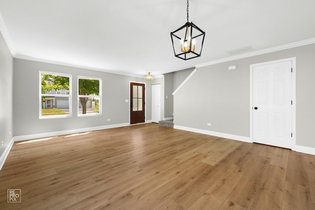 14530 General Dr, Plainfield, IL 60544 - unfurnished living room featuring a chandelier, ornamental molding, and light wood-type flooring
