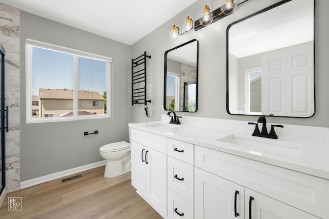 14530 General Dr, Plainfield, IL 60544 - bathroom featuring a marble finish shower, double vanity, wood finished floors, and a towel warmer