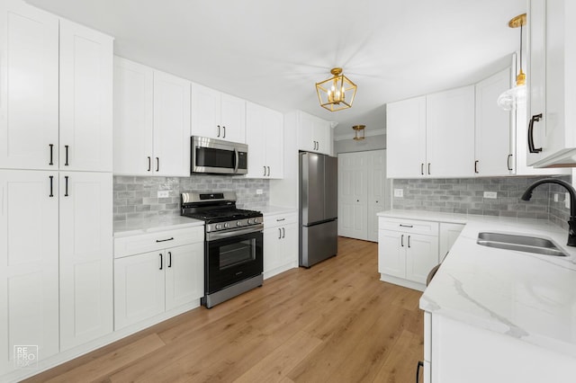 14530 General Dr, Plainfield, IL 60544 - kitchen with appliances with stainless steel finishes, backsplash, light wood-type flooring, and light stone countertops