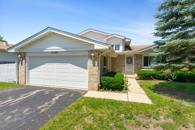 2180 Newport Cir, Hanover Park, IL 60133 - view of front of property with brick siding, asphalt driveway, and a garage