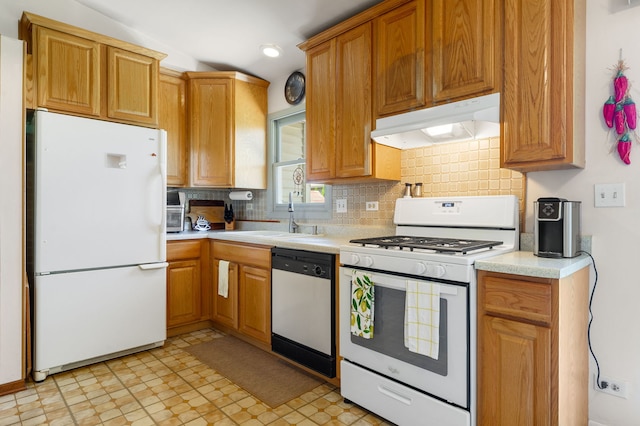 2180 Newport Cir, Hanover Park, IL 60133 - kitchen with white appliances, under cabinet range hood, light countertops, decorative backsplash, and light floors