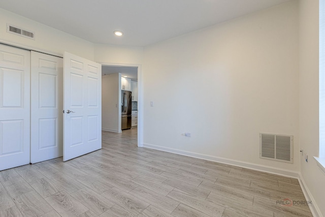640 Robert York Ave Unit 306, Deerfield, IL 60015 - unfurnished bedroom with stainless steel refrigerator with ice dispenser, light wood-style floors, recessed lighting, and a closet