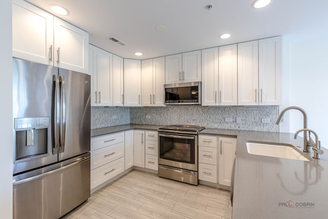 640 Robert York Ave Unit 306, Deerfield, IL 60015 - kitchen featuring stainless steel appliances, white cabinets, backsplash, and recessed lighting