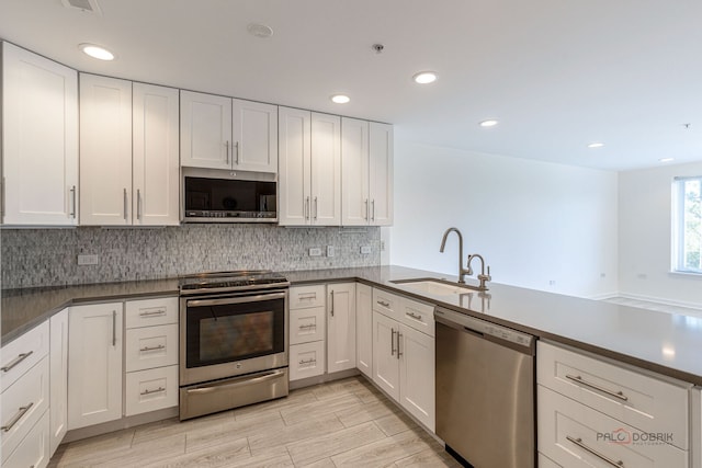 640 Robert York Ave Unit 306, Deerfield, IL 60015 - kitchen featuring stainless steel appliances, decorative backsplash, white cabinets, and recessed lighting