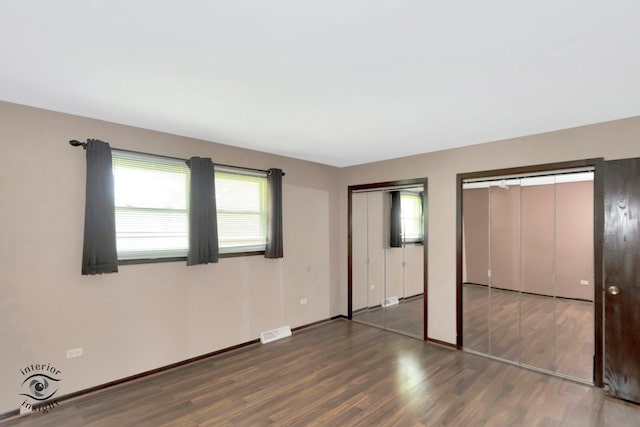 14332 S W Glen Dr, Homer Glen, IL 60491 - unfurnished bedroom with multiple closets and wood finished floors