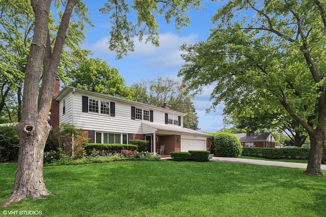 2340 Pomona Ln, Wilmette, IL 60091 - traditional-style home with a chimney, brick siding, a garage, and a front yard