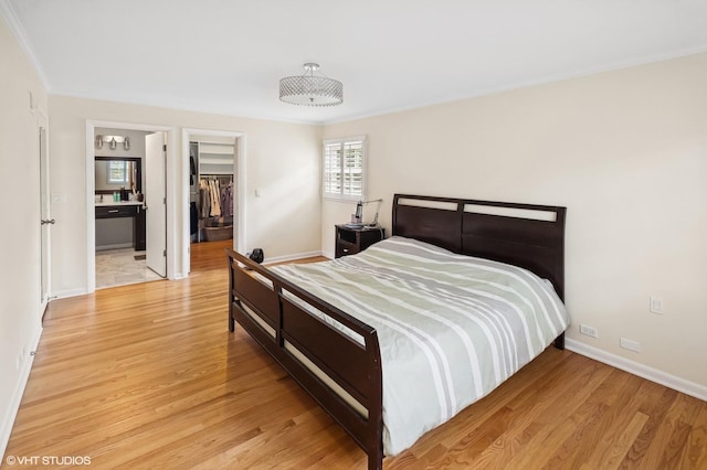 2340 Pomona Ln, Wilmette, IL 60091 - bedroom featuring light wood finished floors, a walk in closet, crown molding, and a closet