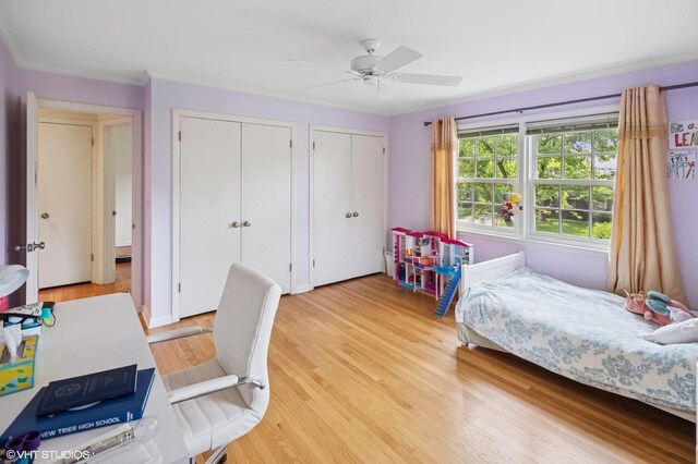 2340 Pomona Ln, Wilmette, IL 60091 - bedroom featuring multiple closets, ornamental molding, light wood finished floors, and a ceiling fan