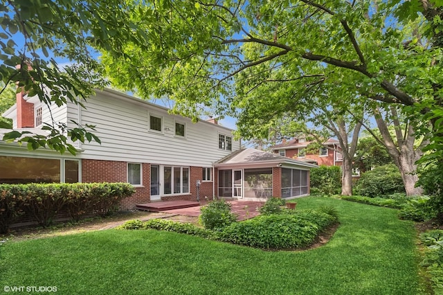 2340 Pomona Ln, Wilmette, IL 60091 - back of house with a sunroom, brick siding, a yard, and a patio area