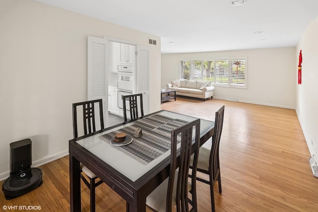 2340 Pomona Ln, Wilmette, IL 60091 - dining room featuring light wood-style floors and baseboards