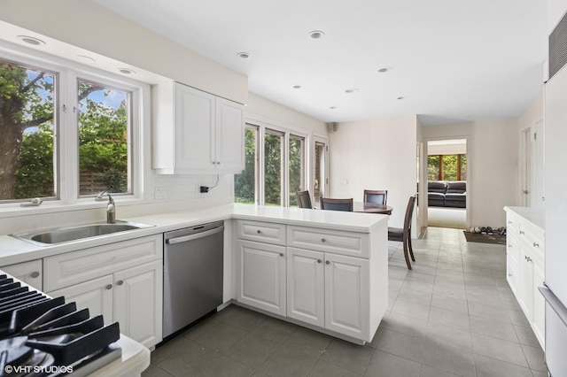 2340 Pomona Ln, Wilmette, IL 60091 - kitchen with stainless steel dishwasher, white cabinets, a peninsula, light countertops, and recessed lighting