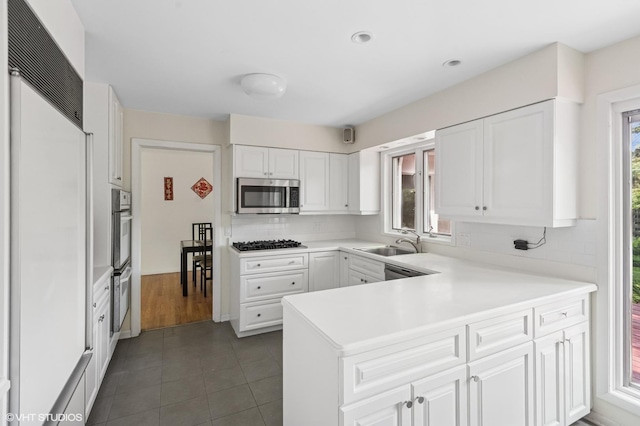 2340 Pomona Ln, Wilmette, IL 60091 - kitchen with stainless steel appliances, a peninsula, backsplash, white cabinetry, and recessed lighting