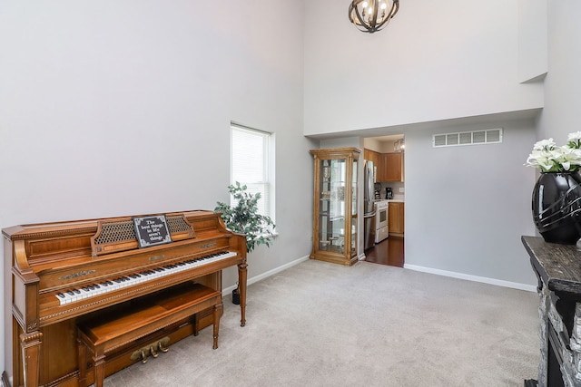 1769 Autumn Woods Ln, Romeoville, IL 60446 - sitting room with a towering ceiling, light colored carpet, and a chandelier