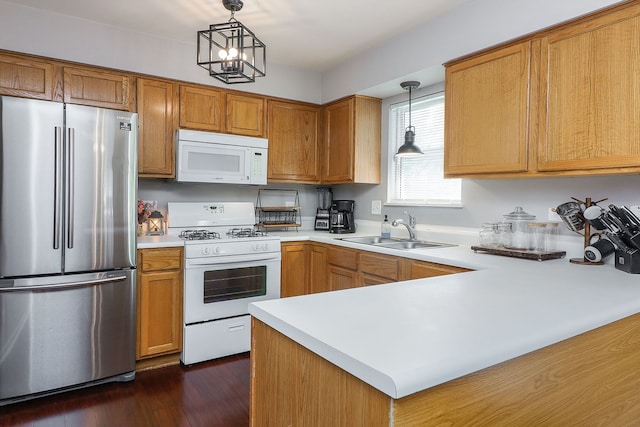 1769 Autumn Woods Ln, Romeoville, IL 60446 - kitchen with white appliances, a peninsula, light countertops, hanging light fixtures, and dark wood-style floors