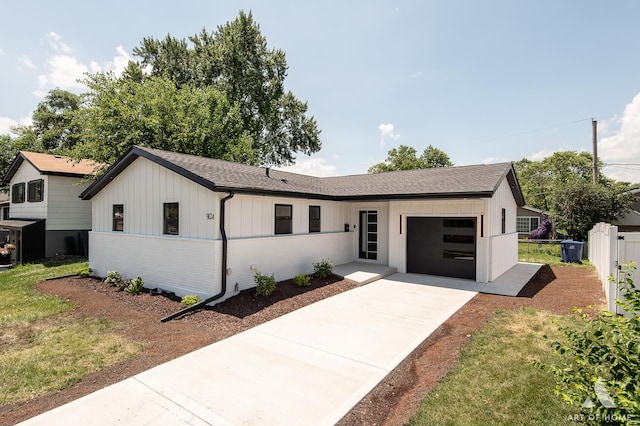 9124 S 88th Ave, Hickory Hills, IL 60457 - view of front facade with a garage, board and batten siding, driveway, and a shingled roof