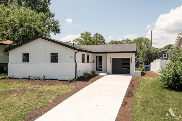 9124 S 88th Ave, Hickory Hills, IL 60457 - view of front of home featuring concrete driveway, an attached garage, board and batten siding, and a shingled roof