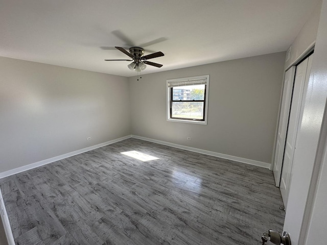 2237 175th St Unit 3A, Lansing, IL 60438 - unfurnished bedroom featuring dark wood finished floors, a closet, and a ceiling fan