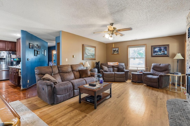 2612 Valkar Ln, Champaign, IL 61822 - living area with light wood-style floors, a ceiling fan, and a textured ceiling