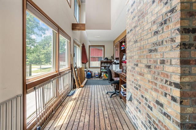 2612 Valkar Ln, Champaign, IL 61822 - home office featuring plenty of natural light, brick wall, and hardwood / wood-style flooring