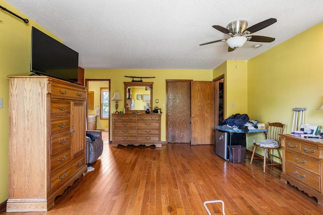 2612 Valkar Ln, Champaign, IL 61822 - bedroom featuring wood-type flooring, a textured ceiling, and ceiling fan