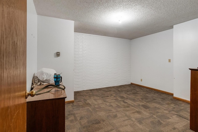 2612 Valkar Ln, Champaign, IL 61822 - carpeted spare room with a textured ceiling and brick wall
