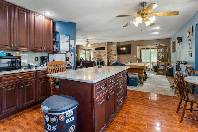 2612 Valkar Ln, Champaign, IL 61822 - kitchen with a ceiling fan, black microwave, dark wood-style flooring, open shelves, and open floor plan