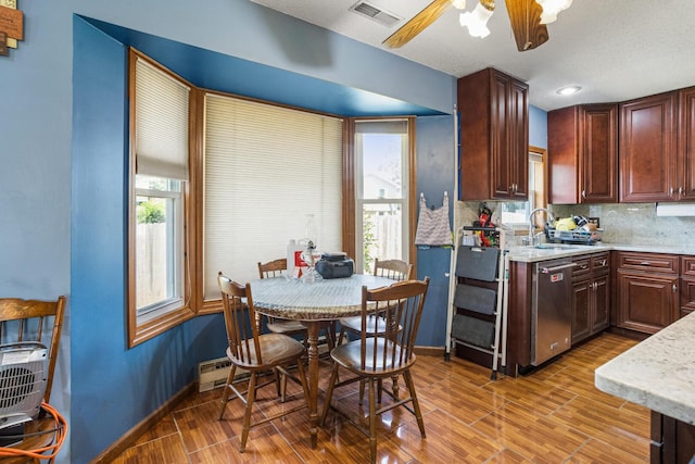 2612 Valkar Ln, Champaign, IL 61822 - kitchen with dishwasher, light wood-type flooring, tasteful backsplash, ceiling fan, and light stone counters