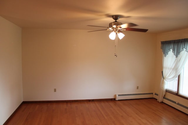 819 S W St, Earlville, IL 60518 - empty room with baseboard heating, wood finished floors, and a ceiling fan