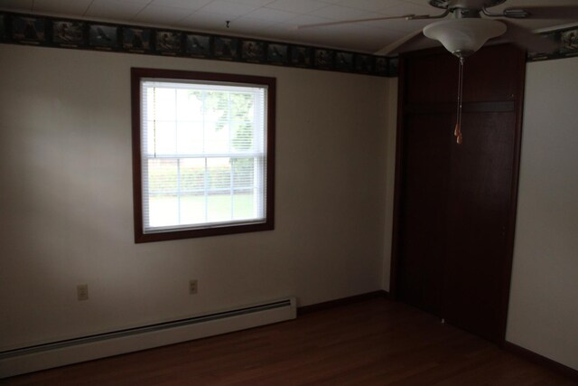 819 S W St, Earlville, IL 60518 - unfurnished room featuring a baseboard radiator, ceiling fan, and wood finished floors