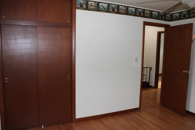 819 S W St, Earlville, IL 60518 - unfurnished bedroom with wood finished floors and a closet