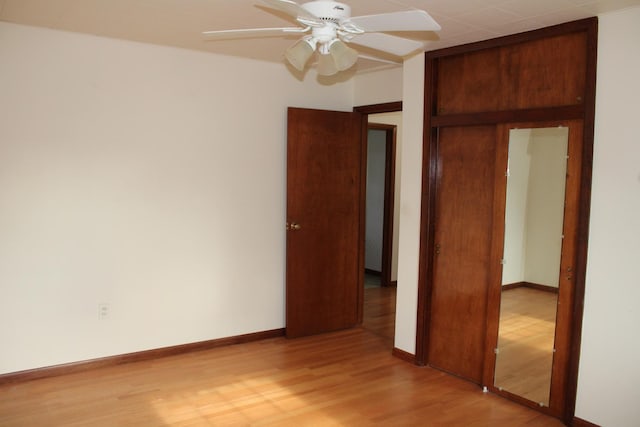 819 S W St, Earlville, IL 60518 - unfurnished bedroom featuring light wood-style flooring, a closet, and ceiling fan
