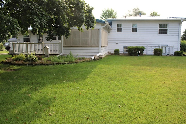 819 S W St, Earlville, IL 60518 - rear view of house with a yard, a sunroom, and a deck