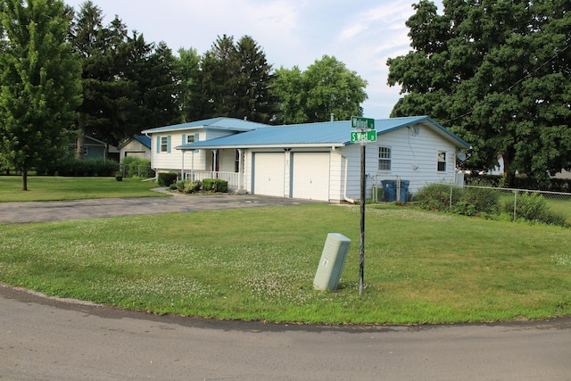 819 S W St, Earlville, IL 60518 - split level home featuring a garage, driveway, and a metal roof