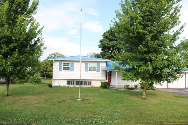 819 S W St, Earlville, IL 60518 - tri-level home with a front lawn, a garage, asphalt driveway, and a metal roof