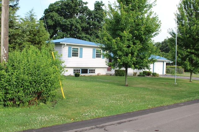 819 S W St, Earlville, IL 60518 - split level home featuring a garage, a front lawn, a metal roof, and driveway