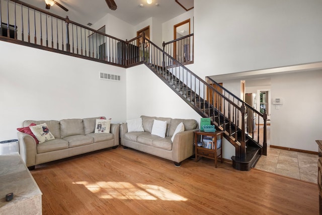 96 Townsend Cir, Naperville, IL 60565 - living area featuring a high ceiling, stairs, wood finished floors, and ceiling fan