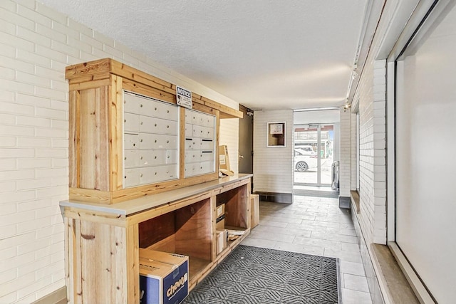 1740 N Marshfield Ave Unit 30, Chicago, IL 60622 - view of home's community featuring brick wall, a textured ceiling, and mail area