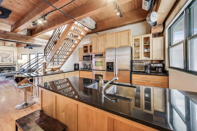 1740 N Marshfield Ave Unit 30, Chicago, IL 60622 - kitchen with appliances with stainless steel finishes, a wood ceiling with exposed beams, rail lighting, plenty of natural light, and light brown cabinets