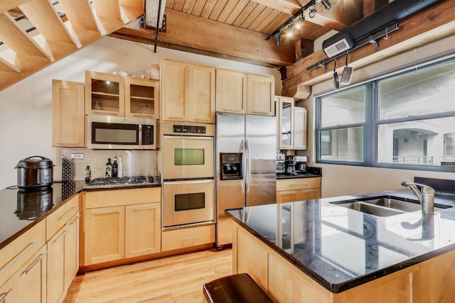 1740 N Marshfield Ave Unit 30, Chicago, IL 60622 - kitchen with appliances with stainless steel finishes, light brown cabinetry, track lighting, a wooden ceiling with exposed beams, and glass insert cabinets