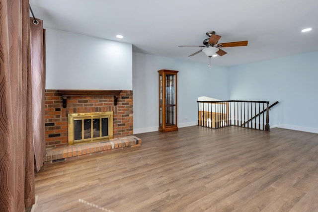 1165 Mayfield Ln, Hoffman Estates, IL 60169 - unfurnished living room featuring ceiling fan, recessed lighting, wood finished floors, and a brick fireplace