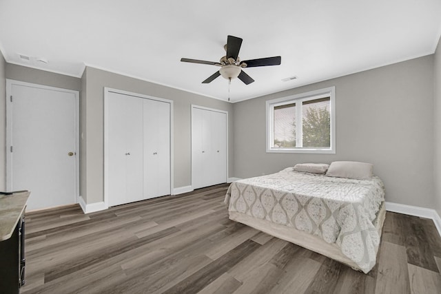 17824 Bernard Dr Unit 3D, Orland Park, IL 60467 - bedroom with multiple closets, wood finished floors, a ceiling fan, and crown molding
