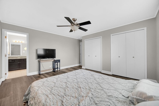 17824 Bernard Dr Unit 3D, Orland Park, IL 60467 - bedroom featuring multiple closets, crown molding, wood finished floors, ensuite bathroom, and a ceiling fan